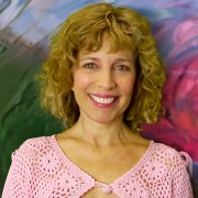 Smiling woman with shoulder-length light brown hair